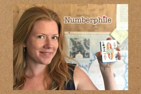 Dr. Krieger holding up some cards with "Numberphile"