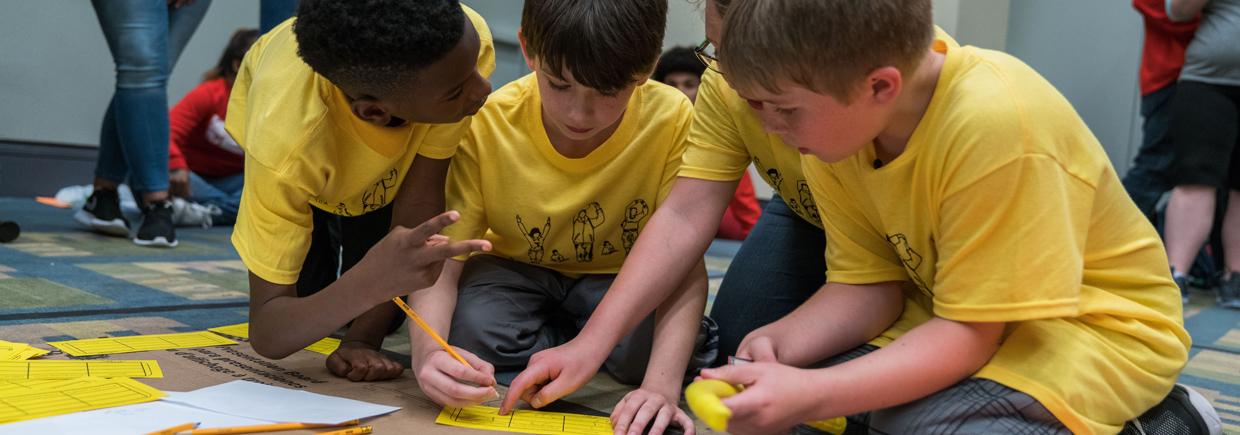 A group of boys working on a math activity