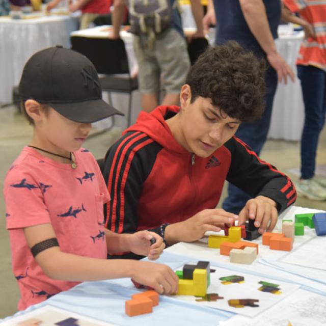 two boys playing with shape blocks - National Math Festival 2019