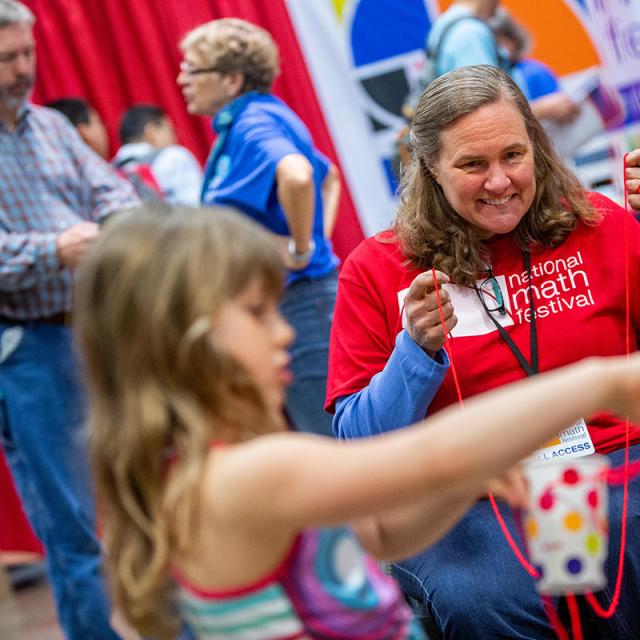 2019 Festival volunteer playing with string