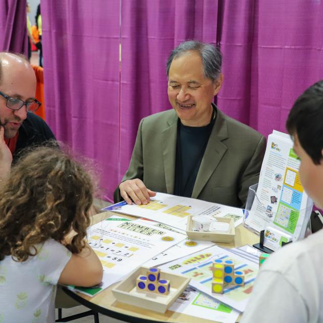 Event Attendees Reading Instructions for tabletop game - National Math Festival 2019