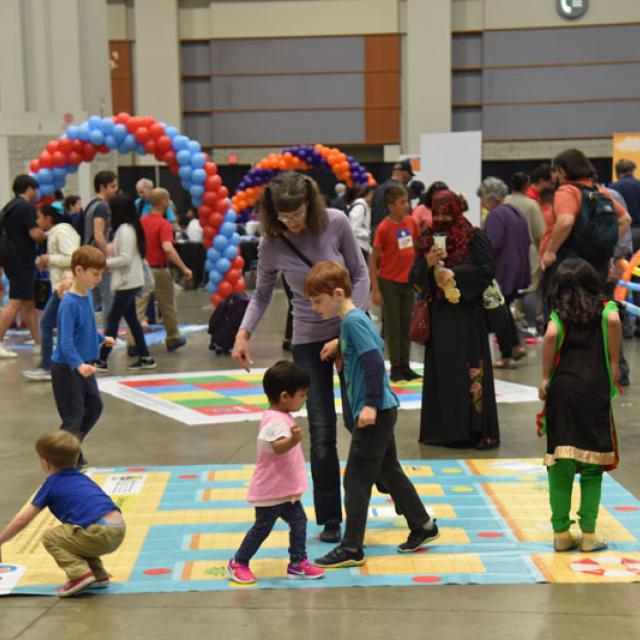 Event attendees playing on activity pad - National Math Festival 2019