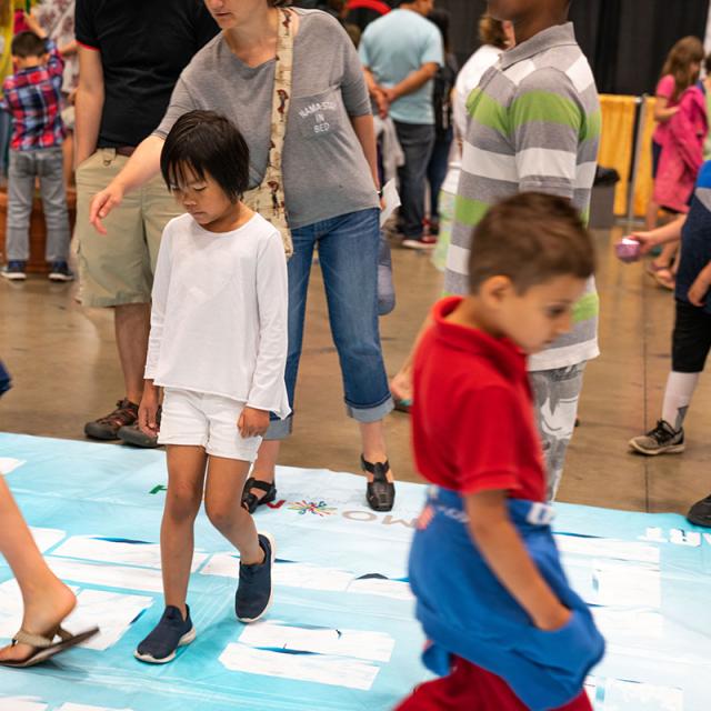 2019 Festival attendees walking on activity mat