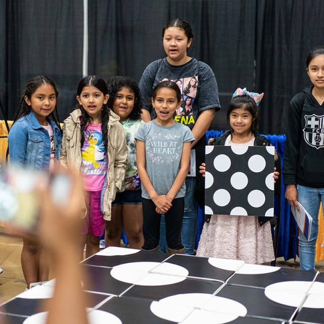 2019 festival attendees posing with large puzzle blocks