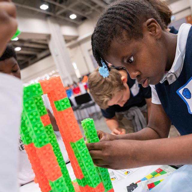 Boy building with blocks at National Math Festival 2019